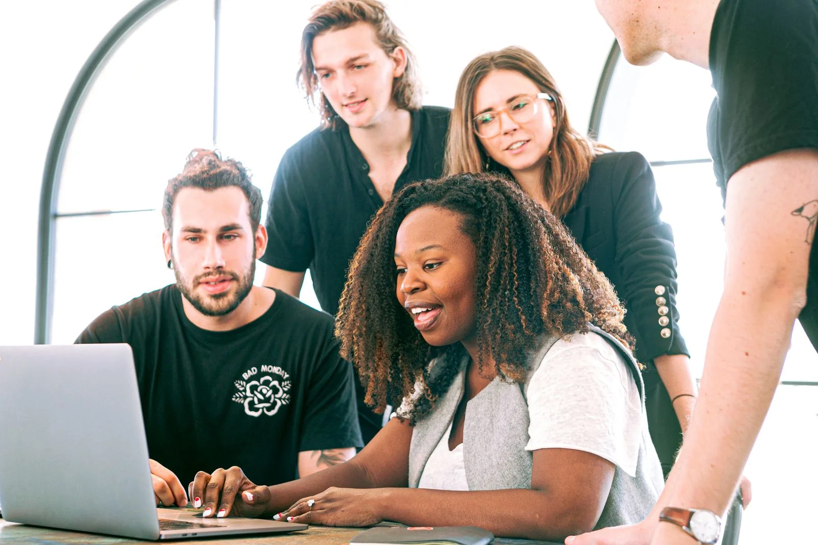 Design team reviewing a website on a laptop